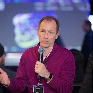A panelist speaking into a microphone at Dirty Jobs Summit
